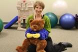 elderly woman holding teddy bear